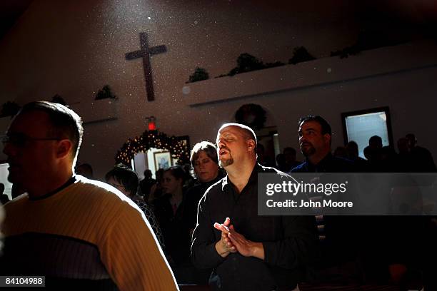 Larry Pendell sings during a a prayer service at the Wilmington Church of God December 21, 2008 in Wilmington, Ohio. The pastor, Elizabeth Looney,...