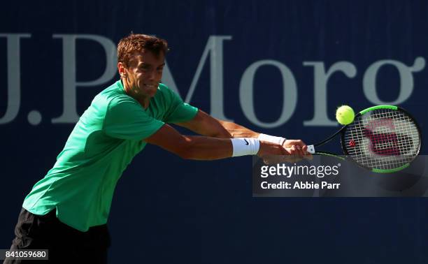Andrey Kuznetsov of Russia returns a shot against Feliciano Lopez of Spain during their first round Men's Singles match on Day Three of the 2017 US...