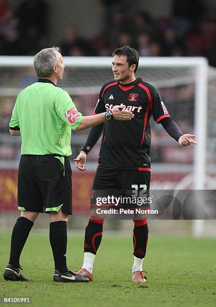 Referee Paul Gibbs talks to Jeff Smith of Carlisle United during the Coca Cola League One Match between Northampton Town and Carlisle United at...