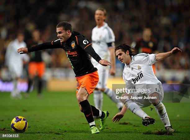 Juan Manuel Mata of Valencia duels for the ball with Fernando Gago of Real Madrid during the La Liga match between Real Madrid and Valencia at the...