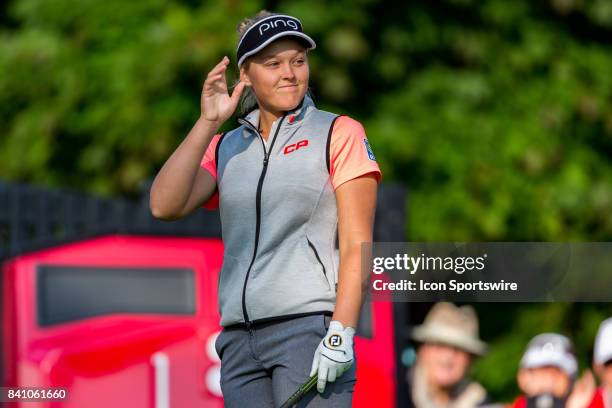 Brooke Henderson waves to the cheering crowd before teeing off on the 1st hole during the third round of the Canadian Pacific Women's Open on August...