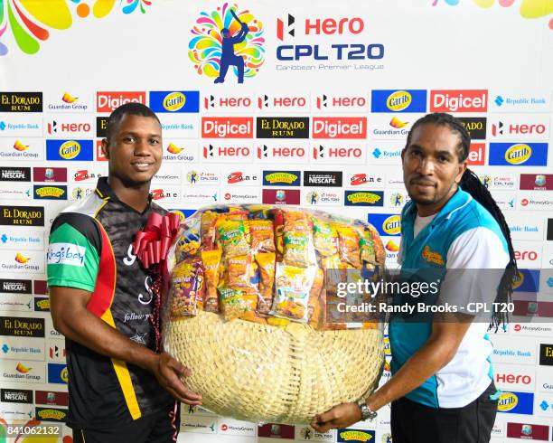 In this handout image provided by CPL T20, Evin Lewis of St Kitts & Nevis Patriots receives the power shot prize at the end of Match 26 of the 2017...