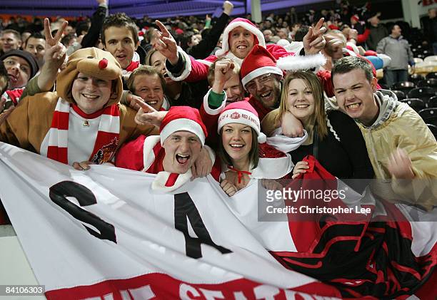 Sunderland fans celebrate their victory during the Barclays Premier League match between Hull City and Sunderland at The KC Stadium on December 20,...