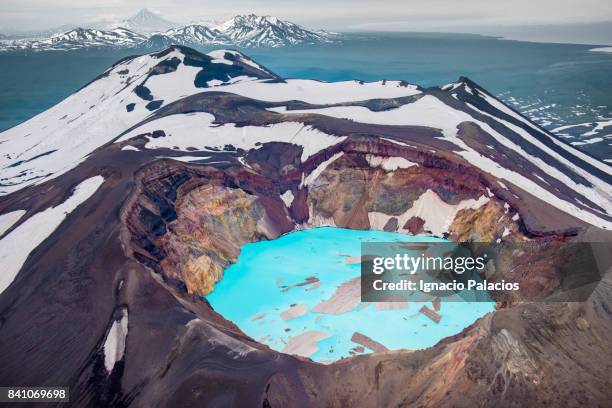 malyi semyachik volcano and its blue lake crater - volcanic terrain stock pictures, royalty-free photos & images