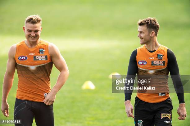 Ollie Wines of the Power chats with Robbie Gray of the Power during a Port Power AFL training session at the Adelaide Oval on August 31, 2017 in...