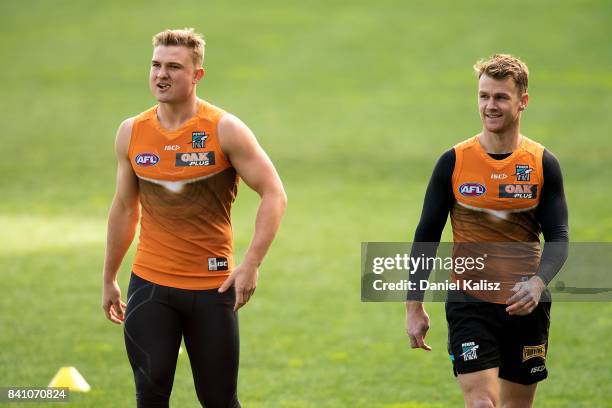 Ollie Wines of the Power chats with Robbie Gray of the Power during a Port Power AFL training session at the Adelaide Oval on August 31, 2017 in...