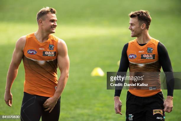 Ollie Wines of the Power chats with Robbie Gray of the Power during a Port Power AFL training session at the Adelaide Oval on August 31, 2017 in...