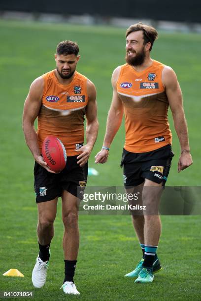 Patrick Ryder and Charlie Dixon of the Power are pictured during a Port Power AFL training session at the Adelaide Oval on August 31, 2017 in...