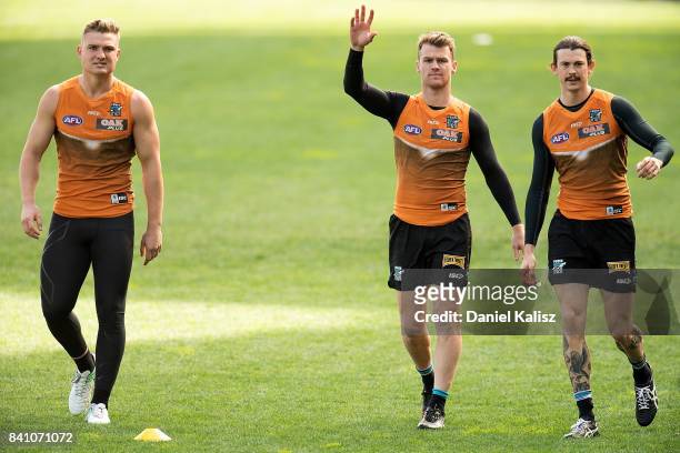 Ollie Wines, Robbie Gray and Jasper Pittard of the Power are pictured during a Port Power AFL training session at the Adelaide Oval on August 31,...