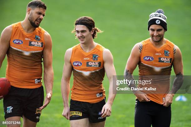 Patrick Ryder, Darcy Byrne-Jones and Chad Wingard of the Power are pictured during a Port Power AFL training session at the Adelaide Oval on August...