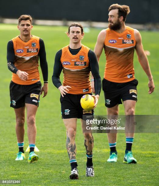 Riley Bonner, Jasper Pittard and Charlie Dixon of the Power are pictured during a Port Power AFL training session at the Adelaide Oval on August 31,...