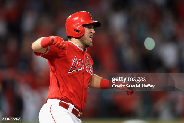 Cliff Pennington of the Los Angeles Angels runs to first base after hitting a grand slam homerun during the seventh inning of a game against the...