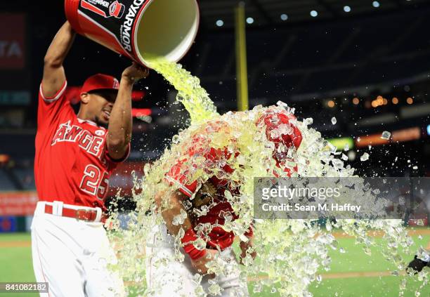 Ben Revere pours a sports drink on Cliff Pennington of the Los Angeles Angels after defeating the Oakland Athletics 10-8 in a game at Angel Stadium...