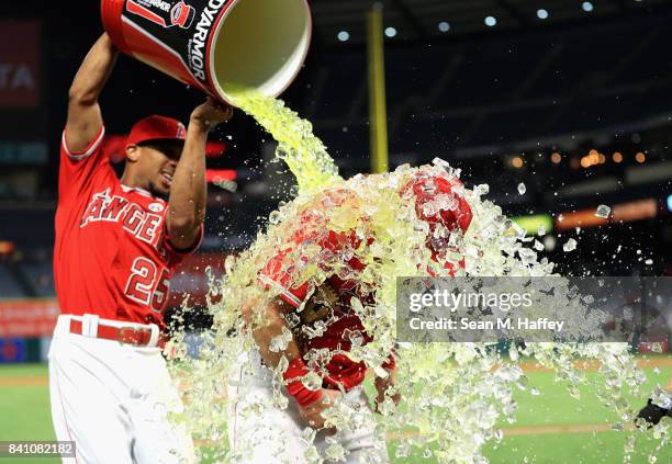 Ben Revere pours a sports drink on Cliff Pennington of the Los Angeles Angels after defeating the Oakland Athletics 10-8 in a game at Angel Stadium...