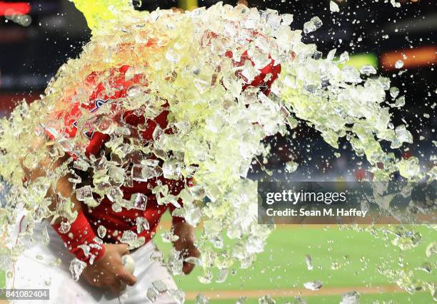 Ben Revere pours a sports drink on Cliff Pennington of the Los Angeles Angels after defeating the Oakland Athletics 10-8 in a game at Angel Stadium...