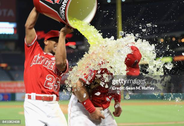 Ben Revere pours a sports drink on Cliff Pennington of the Los Angeles Angels after defeating the Oakland Athletics 10-8 in a game at Angel Stadium...