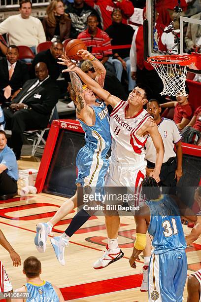 Yao Ming of the Houston Rockets blocks shot by Chris Andersen of the Denver Nuggets during the game at the Toyota Center on December 16, 2008 in...