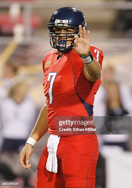 Quarterback Willie Tuitama of the Arizona Wildcats signals his teammates during the Pioneer Las Vegas Bowl against the Brigham Young University...