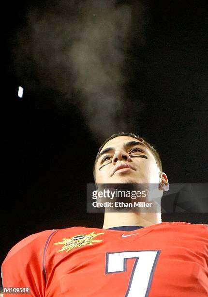 Quarterback Willie Tuitama of the Arizona Wildcats looks out at fans as he celebrates the team's 31-21 victory over the Brigham Young University...