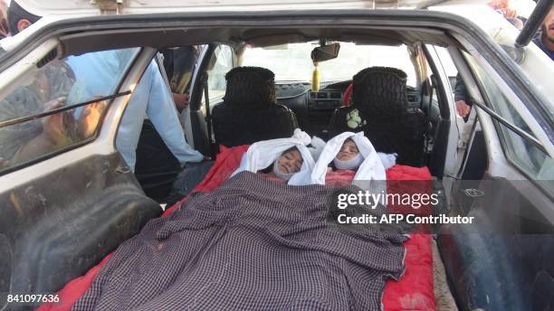 In this picture taken on August 30, 2017 the dead bodies of children are seen in a car in Dasht-e-Bari village in Logar province near Kabul. Thirteen...