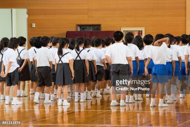 Elementary students gather in the school gym after a loud siren warning during an evacuation drill in preparation for a North Korea'n ballistic...