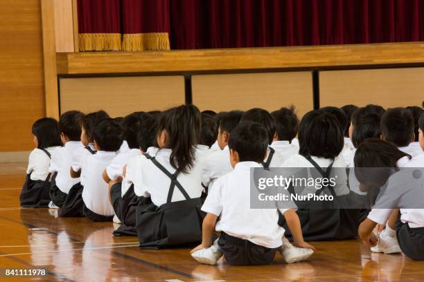 Elementary students gather in the school gym after a loud siren warning during an evacuation drill in preparation for a North Korea'n ballistic...