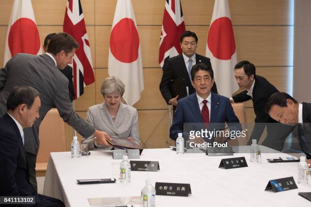 Prime Minister Theresa May and her Japanese counterpart Shinzo Abe meet with Japan's National Security Council at the Prime Minister's office in...