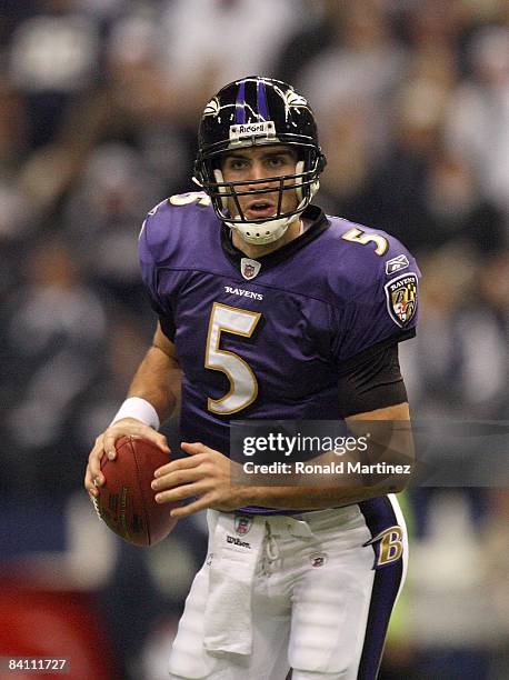 Quarterback Joe Flacco of the Baltimore Ravens runs to his right and looks for the open receiver during their NFL game against the Dallas Cowboys at...