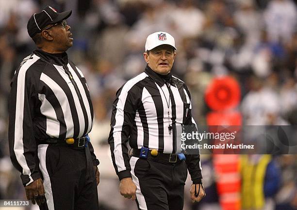 Referee Ed Hochuli, right, looks on during the NFL game between the Baltimore Ravens and the Dallas Cowboys at Texas Stadium on December 20, 2008 in...