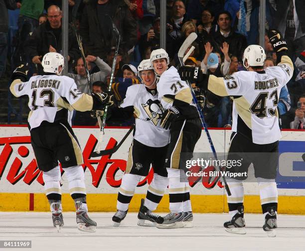 Sidney Crosby of the Pittsburgh Penguins celebrates with Evgeni Malkin after tipping in the winning goal 43 seconds into overtime against the Buffalo...