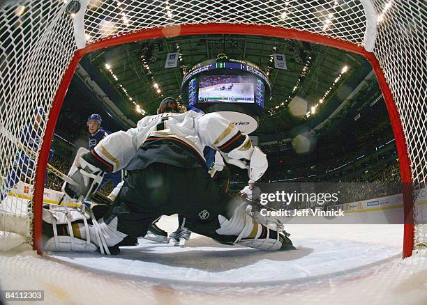 Mason Raymond of the Vancouver Canucks watches a shot get by Jonas Hiller of the Anaheim Ducks during their game at General Motors Place on December...