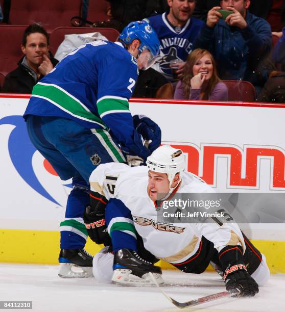 Ryan Getzlaf of the Anaheim Ducks gets knocked down to the ice by Mattias Ohlund of the Vancouver Canucks during their game at General Motors Place...