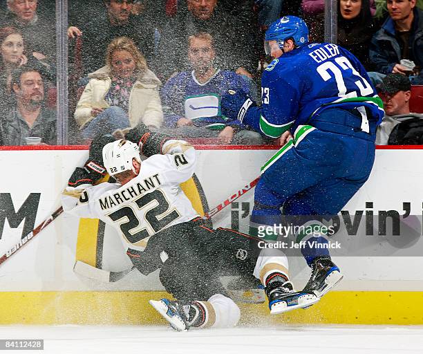 Alexander Edler of the Vancouver Canucks crashes into Todd Marchant of the Anaheim Ducks along the boards during their game at General Motors Place...