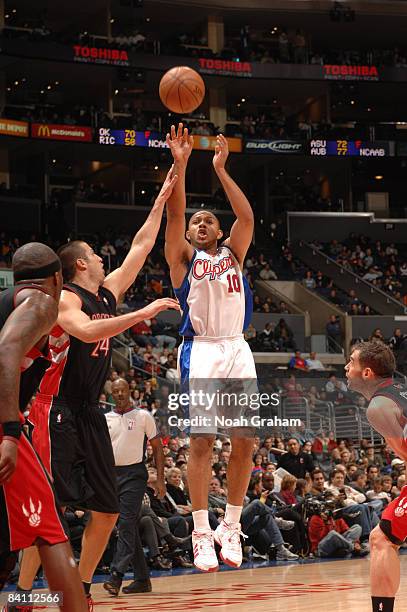 Eric Gordon of the Los Angeles Clippers shoots against Jason Kapono of the Toronto Raptors at Staples Center on December 22, 2008 in Los Angeles,...