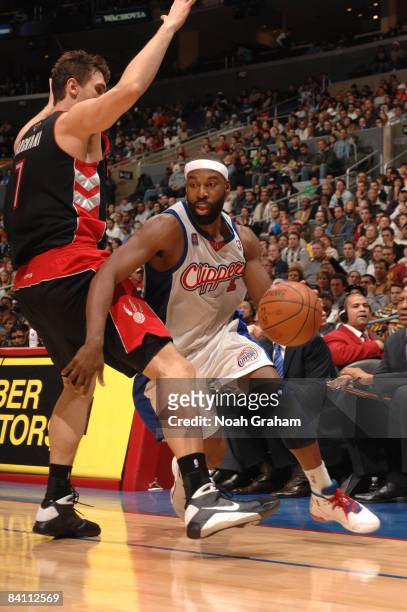 Baron Davis of the Los Angeles Clippers drives around Andrea Bargnani of the Toronto Raptors at Staples Center on December 22, 2008 in Los Angeles,...
