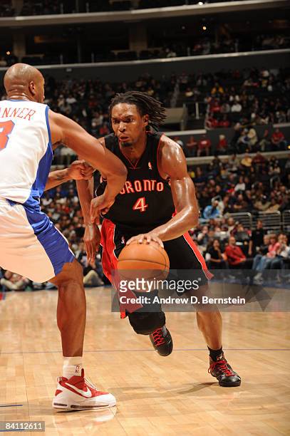 Chris Bosh of the Toronto Raptors handles the ball against Brian Skinner of the Los Angeles Clippers at Staples Center on December 22, 2008 in Los...