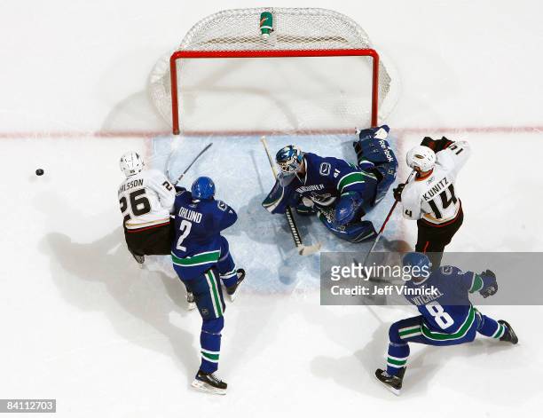 Goaltender Curtis Sanford of the Vancouver Canucks makes a save off the shot of Samuel Pahlsson of the Anaheim Ducks during their game at General...