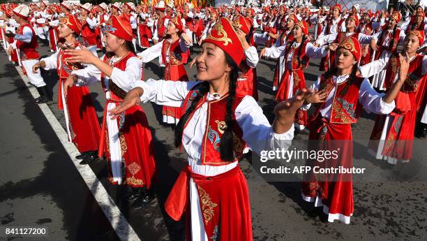 Kyrgyz dancers in traditional costumes perform during celebrations marking the 26th anniversary of Kyrgyzstan's independence from the Soviet Union at...