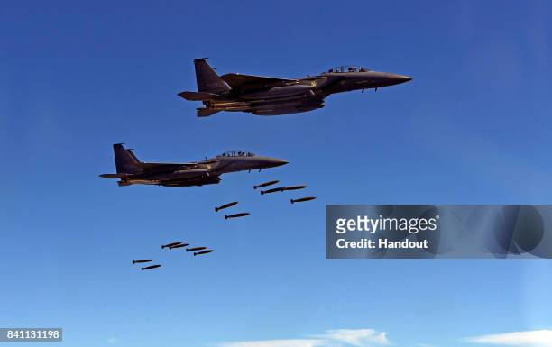 In this handout image provide by South Korean Defense Ministry, South Korea's F-15K fighter jets drop bombs during a training at the Taebaek Pilsung...