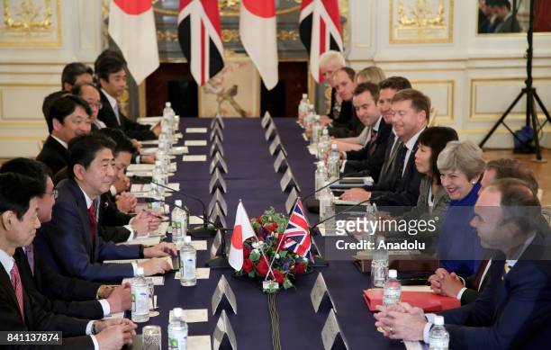 British Prime Minister Theresa May speaks with her Japanese counterpart Shinzo Abe during their meeting at the Akasaka Palace State Guest House in...