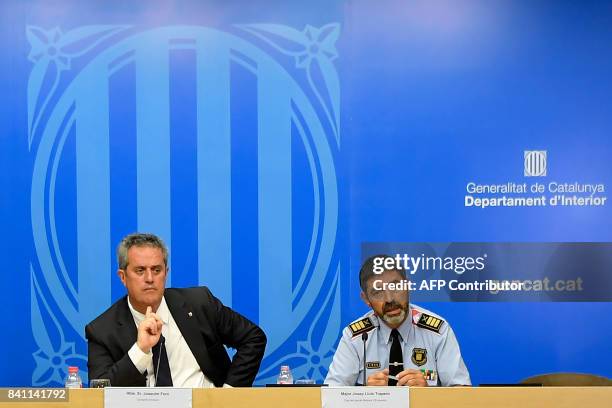Josep Lluis Trapero, chief of the Catalan regional police "Mossos D'Esquadra" and Interior Minister for the Catalan government Joaquim Forn give a...