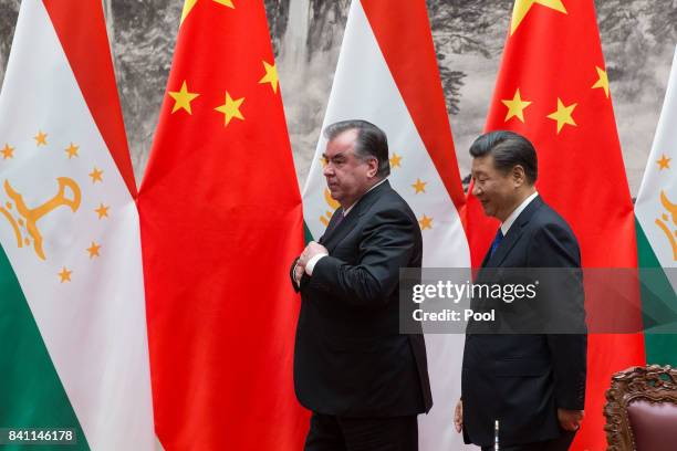 Chinese President Xi Jinping with Tajikistan's President Emomali Rahmon attend the signing ceremony during their meeting at the Great Hall of the...