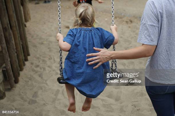 Anna gives her daughter Heidi a push on a swing at a playground on August 31, 2017 in Berlin, Germany. With approximately three weeks to go before...