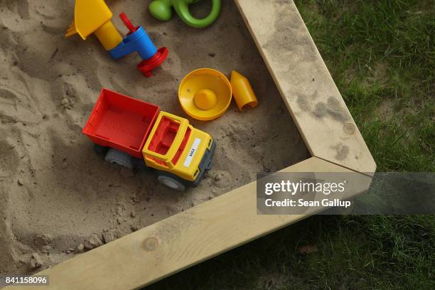 Sandbox with a child's toys lies in a garden on August 31, 2017 in Berlin, Germany. With approximately three weeks to go before federal elections in...