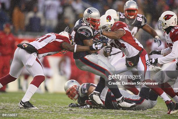 New England Patriots running back Sammy Morris is in action, tackle by Arizona Cardinals cornerback Antrel Rolle and Arizona Cardinals safety Adrian...