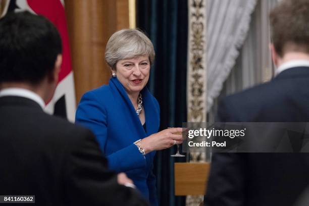 Japanese Prime Minister Shinzo Abe welcomes British Prime Minister Theresa May to the Akasaka Guest House in Tokyo where they attended an official...