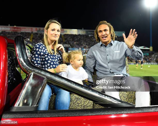 Retiring Cowboy Ray Thompson waves to the crowd during a lap of hounour with his family before the start the round 26 NRL match between the North...