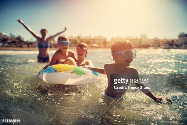 family having fun in summer sea - beach holiday stock pictures, royalty-free photos & images