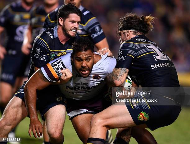 Sam Thaiday of the Broncos is tackled by Ethan Lowe and Lachlan Coote of the Cowboys during the round 26 NRL match between the North Queensland...