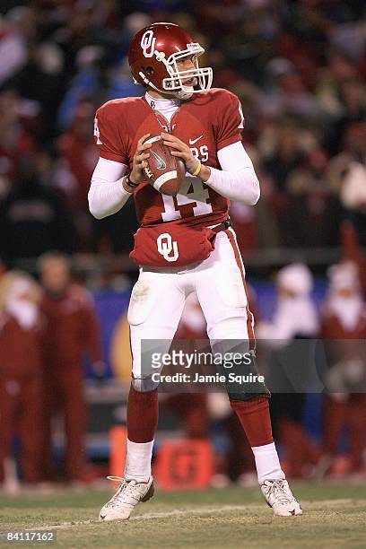 Quarterback Sam Bradford of the Oklahoma Sooners looks to pass the ball during the Big 12 Championship game against the Missouri Tigers on December...